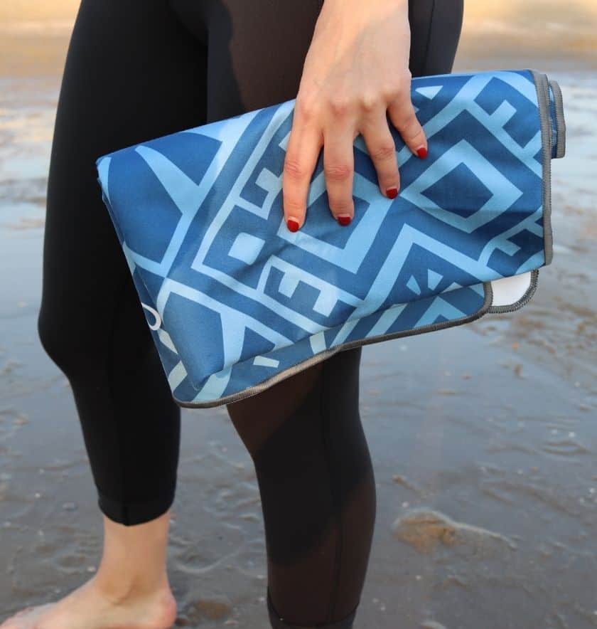 yogini holding a blue yoga towel