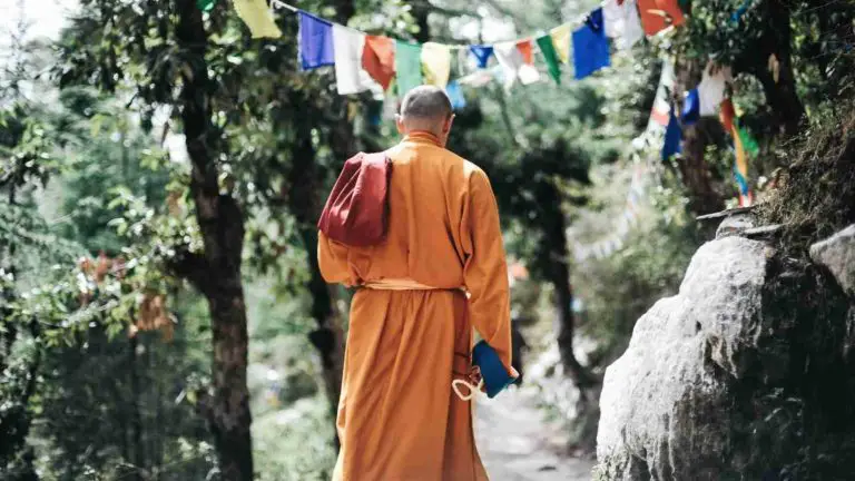 Buddhist monk in the mountains practicing walking meditation